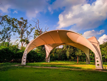 Built structure on field against sky