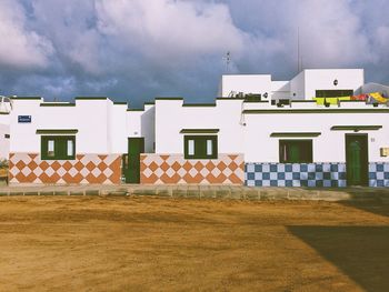 Houses against cloudy sky
