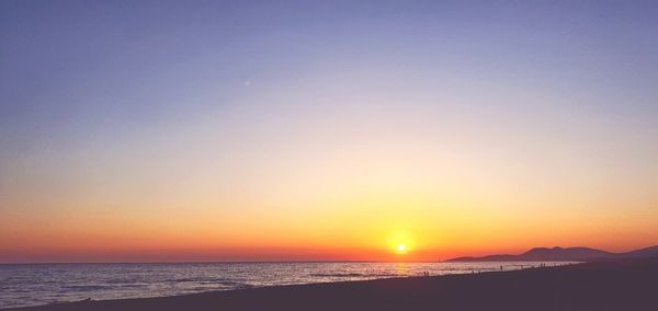 Scenic view of sea against clear sky during sunset