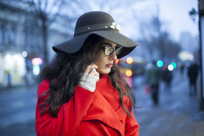 Close-up of young woman talking on phone in city
