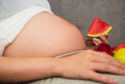 Midsection of woman holding book