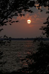 Scenic view of sea against orange sky