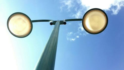 Low angle view of street light against blue sky