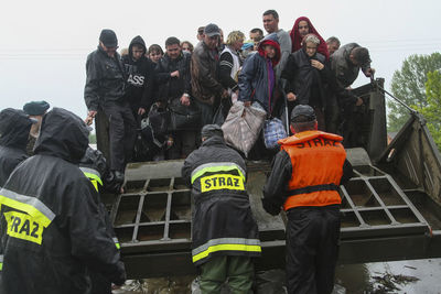 Men standing on people