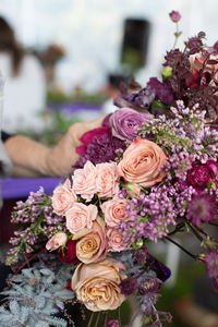 Close-up of woman holding bouquet of roses