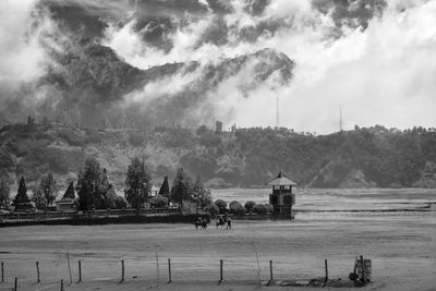 Luhur poten temple against misty mountains at mount bromp