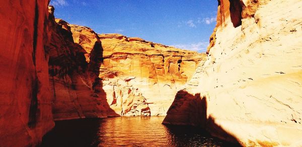 Rock formations by mountain against sky