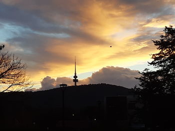 Silhouette of building against sky during sunset