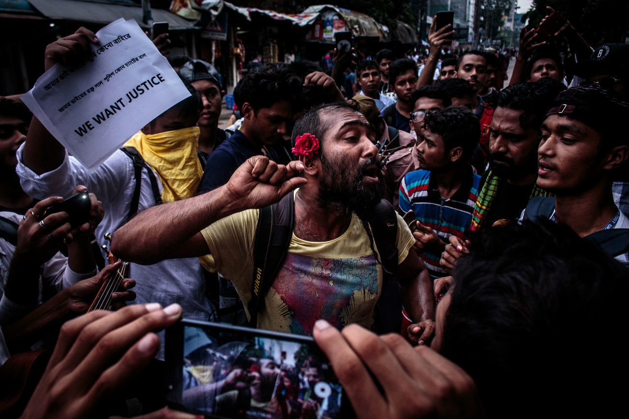 crowd, group of people, real people, large group of people, men, communication, holding, lifestyles, technology, event, adult, city, street, wireless technology, emotion, women, leisure activity, protest, performance, spectator