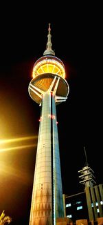 Low angle view of illuminated building against sky at night