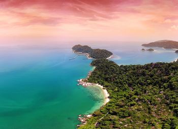 Aerial view of sea against dramatic sky during sunset