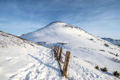 Snow covered mountain against sky