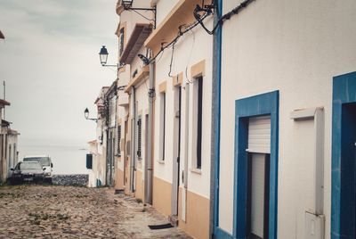 Street amidst buildings against sky