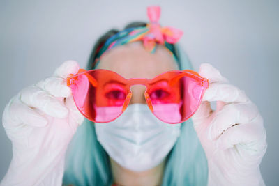 Portrait of woman with mask and sunglasses