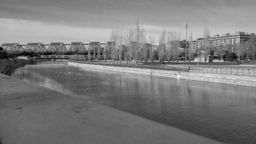 Panoramic view of river by city against sky