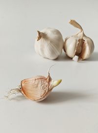 Close-up of garlic on white background