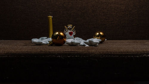 Close-up of toys on table against black background