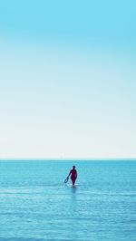 Man on sea against clear sky
