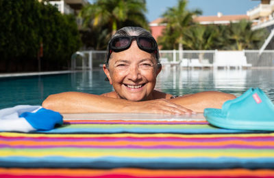 Portrait of smiling man swimming in pool