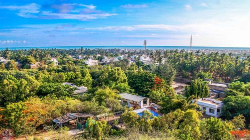 High angle view of townscape by sea against sky