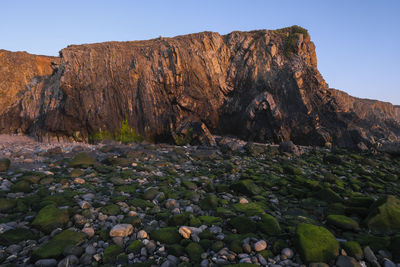 Rock formation on land against clear sky