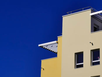 Low angle view of building against blue sky