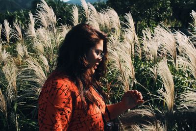 Young woman looking away on field