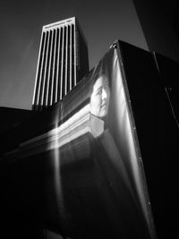 Low angle portrait of man against illuminated building