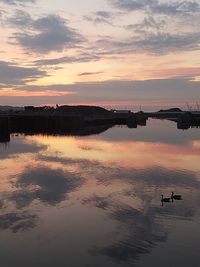 Scenic view of lake against sky during sunset