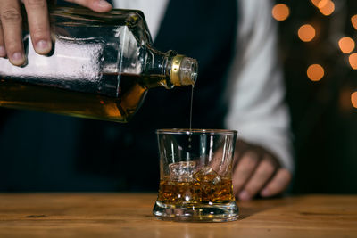 Midsection of wine glasses on table