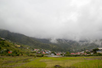 Scenic view of landscape and buildings against sky