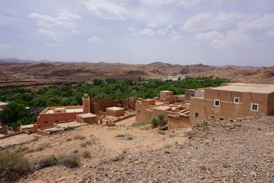 Residential district on field against sky