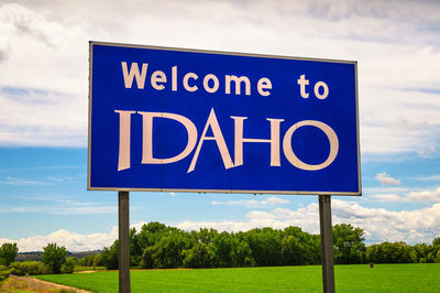 Low angle view of road sign against sky