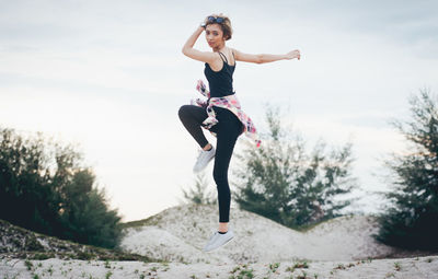 Full length of young woman running