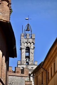 Low angle view of building against clear blue sky