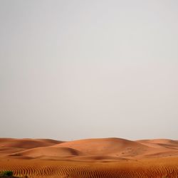 Scenic view of desert against clear sky