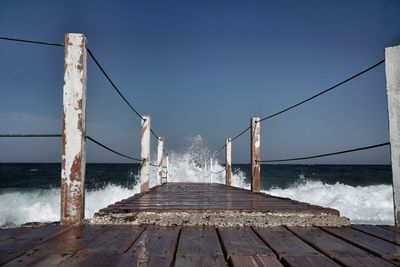 Sea waves splashing against pier