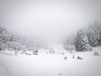 Scenic view of snow covered field against sky