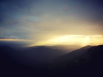 Scenic view of silhouette mountains against sky at sunset