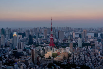 Aerial view of buildings in city during sunset