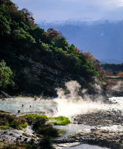 Scenic view of waterfall against sky