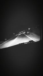 Road seen through car windshield at night