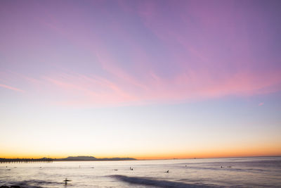 Scenic view of sea against romantic sky at sunset