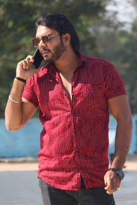 Young man wearing sunglasses standing outdoors