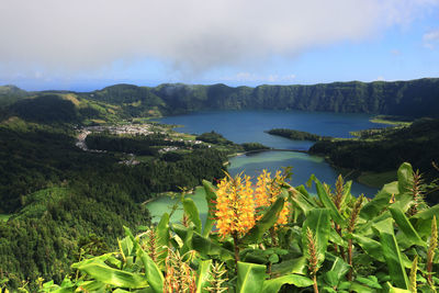 Scenic view of sea and mountains against sky