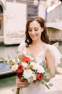 Young woman holding flower bouquet