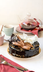 Delicious three chocolates cake with tea on white background