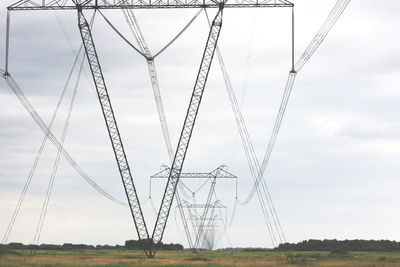 Electricity pylons on field