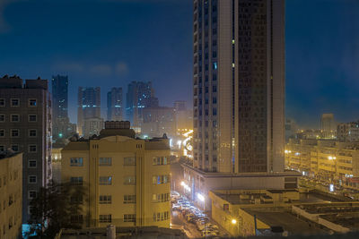 View of skyscrapers lit up at night