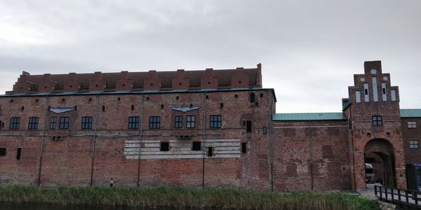 Buildings against cloudy sky